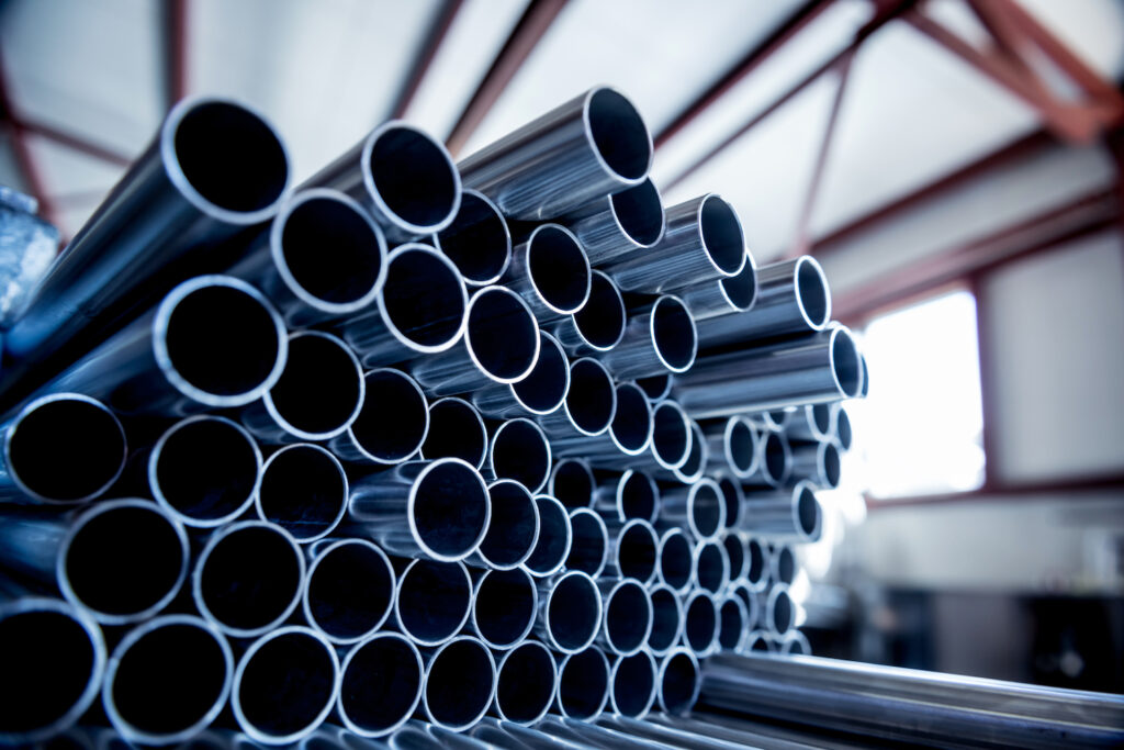 Abstract background of steel pipes stacked on a pallet.